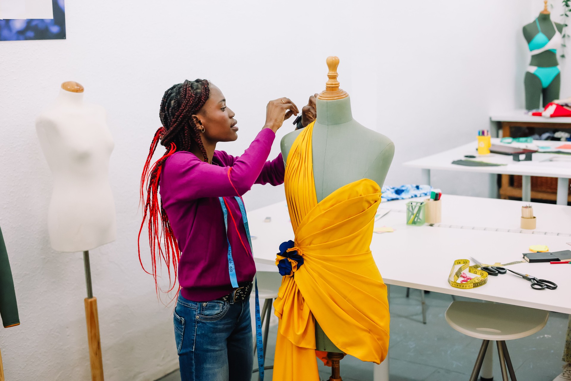 Dressmaker adjustng a dress